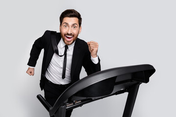 Profile portrait of sporty determined person run treadmill empty space offer isolated on grey color background