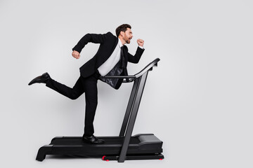 Full length profile photo of determined sportive man run treadmill empty space ad isolated on grey color background