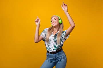 Photo of carefree gorgeous girl with long hairdo dressed shirt in headphones dancing hold hands up...