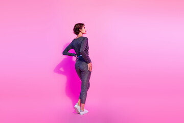 Fototapeta na wymiar Full length photo of slim shiny lady wear glamour overall looking empty space isolated pink color background