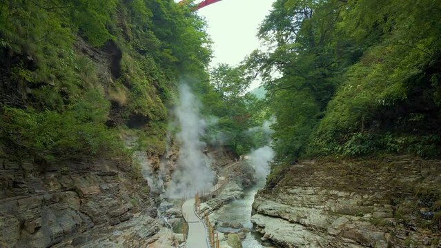 Cinematic aerial shot of steam vents at Oyasukyo Gorge in Akita prefecture in Japan