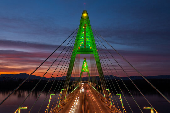 Aerial close up view about the illuminated Megyeri bridge in a rare christmas decorations with stunning sunset at the background.