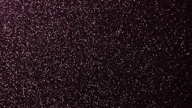 Slow moving dark red sparkly background space-like stars constantly glistening 