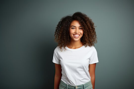 Young Outgoing Woman Smiling and Wearing a Blank T-shirt Standing in Front of a Green Background, Print on Demand Template, Fashion Portrait, People Wearing Clothing with Print Copy Space