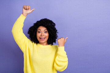 Photo of impressed woman with afro hairstyle dressed yellow sweater directing at offer empty space...