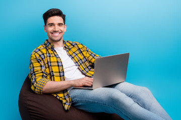Photo of handsome young guy it specialist working remote programming his own website for junior...