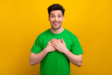 Photo of attractive young brunet man hands touch chest excited grateful dressed stylish green...