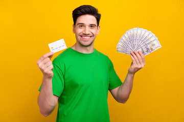 Photo portrait of attractive young brunet man hold money fan credit card dressed stylish green...