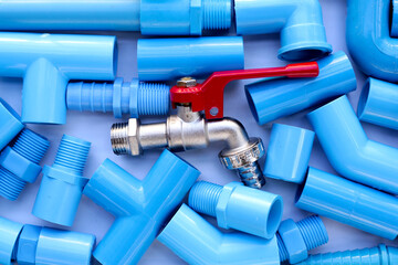 Faucet with blue pvc pipe connections for plumbing work. Plumber equipment