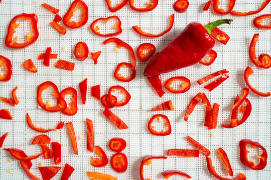 Fresh sliced red chili peppers on white background