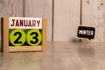 January 23rd.January 23 white wooden calendar on wood background. Copyspace for your text.