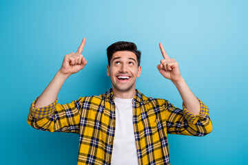 Photo of good mood excited man dressed yellow plaid shirt looking showing two fingers up empty...