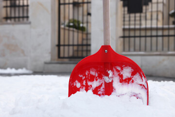 Snow shovel with wooden handle outdoors. Space for text