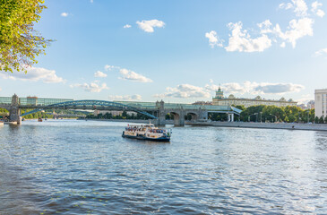 View of the Moscow river embakment, Pushkinsky bridge and cruise ships at sunset.
