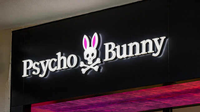 Honolulu, Hawaii \ USA - November 11 2023: Sign and logo of Psycho Bunny men's clothing company on a wall at Ala Moana shoping mall