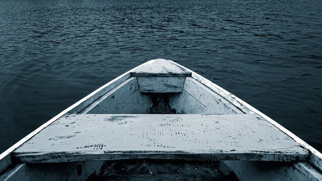 traditional wooden boat facing in the water at the pier. Close up photo