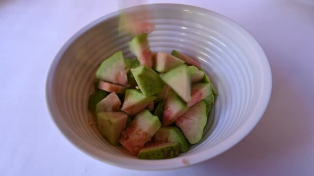 Slices of Guava. It is &nbsp;is a common&nbsp;tropical fruit. Its other names common guava, Psidium guajava, lemon guava, apple guava. This is is a small tree in the myrtle&nbsp;family. Ripe Guava.
