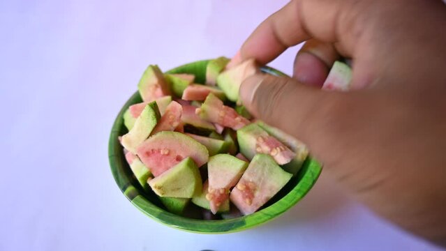 Slices of Guava. It is &nbsp;is a common&nbsp;tropical fruit. Its other names common guava, Psidium guajava, lemon guava, apple guava. This is is a small tree in the myrtle&nbsp;family. Ripe Guava.