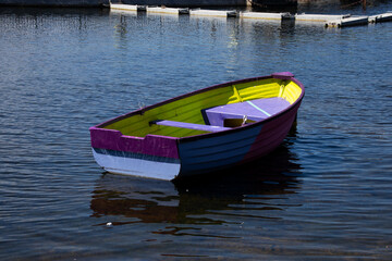 A colourful boat on calm water