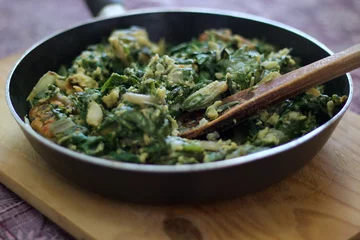 Foto op Canvas chard greens cooked in a frying pan, on a chopping board, on a chopping board © Rodrigo