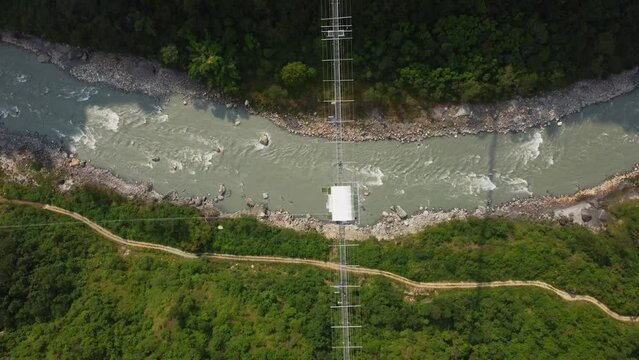 Kushma suspension bridge above river in Nepal 