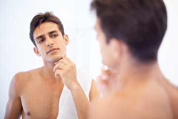 Man, grooming and towel after washing face in mirror, cleaning and skincare or beauty. Male person,...