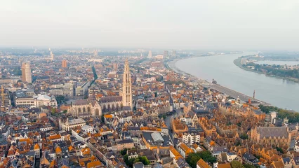 Tuinposter Antwerpen Antwerp, Belgium - July 21, 2023: Spire with the clock of the Cathedral of Our Lady (Antwerp). City Antwerp is located on river Scheldt (Escaut). Summer morning, Aerial View