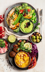 Vegan tasty hummus, herb hummus, beetroot hummus on a light wood background.