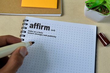 Definition of Affirm word with a meaning on a book. Dictionary concept