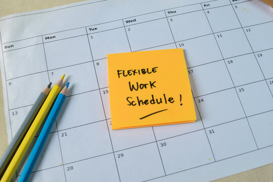 Concept of Flexible work schedule write on sticky notes isolated on Wooden Table.