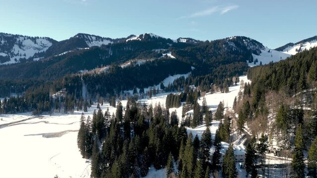 Captivating Aerial Drone View of Winter Mountains in Bavarian Alps, Germany: Snow-Blanketed Landscape near Spitzingsee Lake, Alpine Majesty from Above