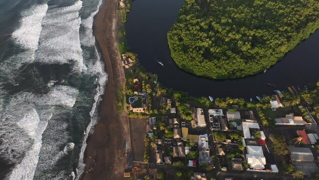 Top down view of El paredon black sand beach during sunrise, aerial