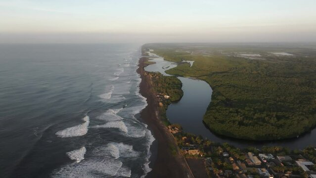 Wide view of El paredon surfing village at Guatemala during sunrise, aerial