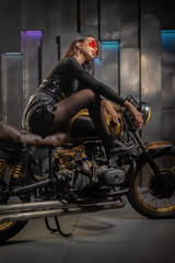 Obraz na płótnie Canvas Young beautiful girl with dark hair on the old motorbike. Girl motorbiker.