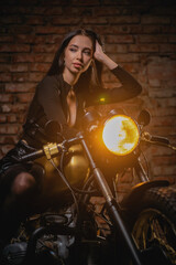 Plakat Young beautiful girl with dark hair on the old motorbike. Girl motorbiker.