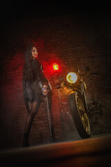 Fototapeta na wymiar Young beautiful girl with dark hair on the old motorbike. Girl motorbiker.