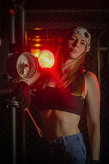 Plakat Girl with the wrench tool posing in the dark. Mechanic concept.