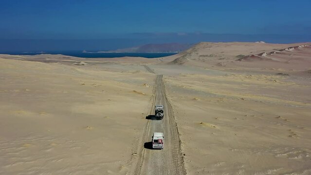 Overlanders Driving Sand Track Paracas National Reserve Expedition Truck Van Blue Sky Pacific Ocean Dune