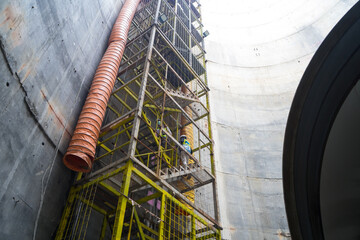 Step zigzag staircase safety with net fall-protection in underground construction site or fire...