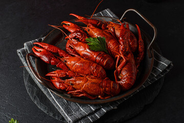 boiled crayfish on a black plate
