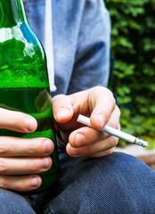 Beer and Cigarette in Hands closeup
