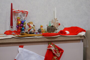 Photo zone, Christmas and New Year. Suitable for backgrounds, Christmas and New Year cards. The table is laid with a linen tablecloth with New Year's toys and Christmas accessories.