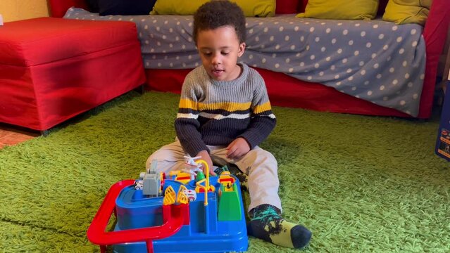 Clever 3-year-old black child playing at home with skill-based toy.