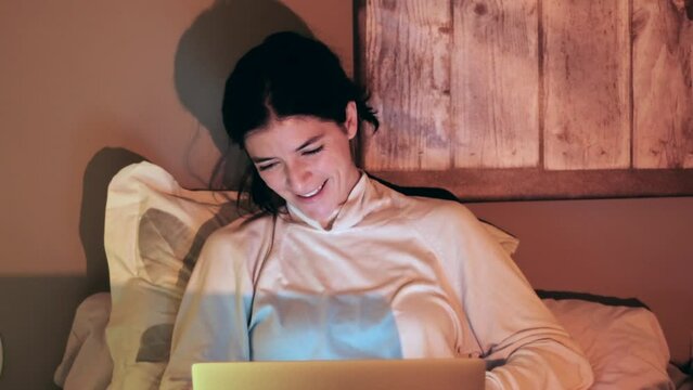 Happy Laughing Woman Having Conference Via Laptop Computer, Sitting On Bed