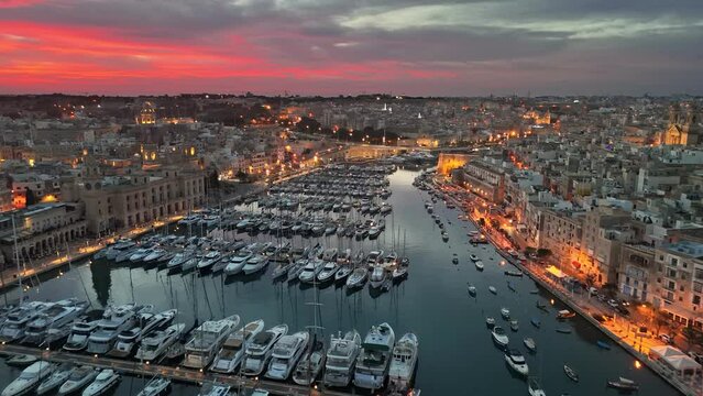 Epic evening shot of old town with churches and marina with yacht in Malta. Aerial sunrise view of three cities - Vittoriosa, Senglea and Cospicua - Malta.