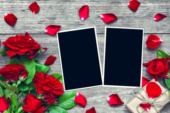 valentines day background. blank photo frames with red rose flowers bouquet and gift box
