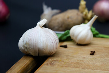 garlic and onion on wooden table, garlic, tomatoes, artichoke. Fresh produce