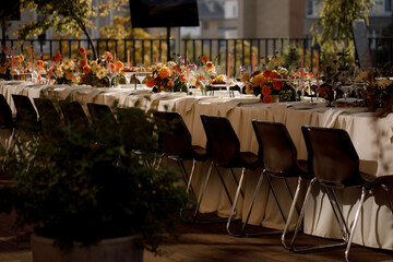 Decorated plate with fork and spoon. Table set up in boho style with pampas grass and greenery