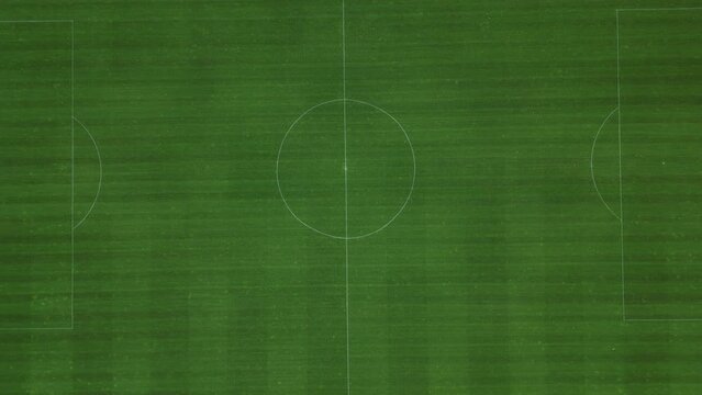 sports stadium football match with several goals. the children here have a series of elimination school grade matches. observe the swarm vertically downwards. mowed stripes lawn