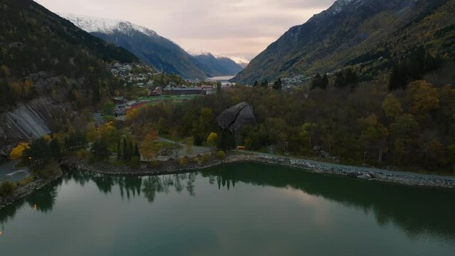aerial approaching to largest rock Norges st&oslash;rste stein in norway at the coast of odda city with mountians on background